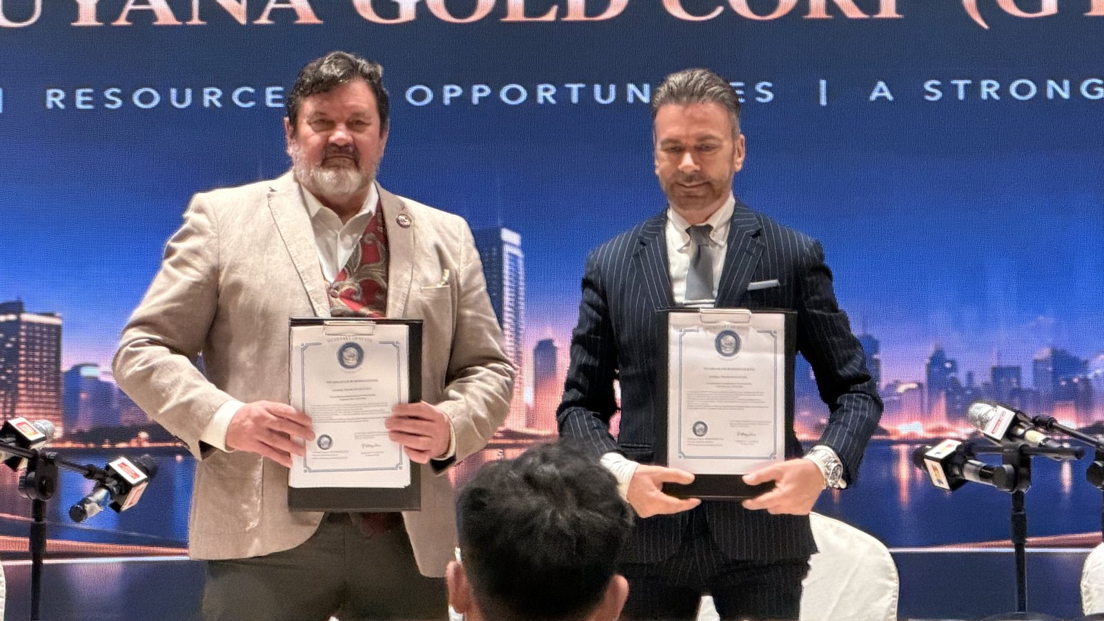 Global Trade Finance and Guyana Gold Corp. representatives presenting the signed agreement